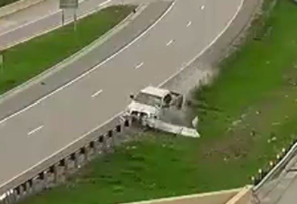 Video: Pickup crashes into I-694 guard rail, barrel rolls over concrete wall to road below