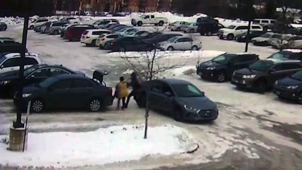 Surveillance video shows woman robbed, dragged by car in St. Paul