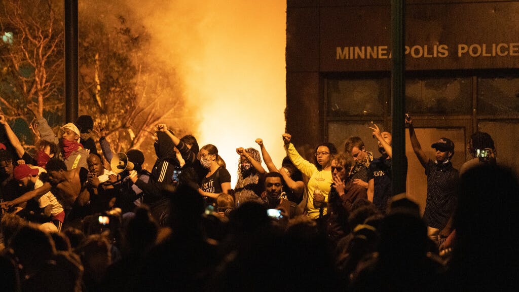 An angry crowd broke into the Minneapolis Police Department's Third Precinct headquarters Thursday night and set fire to the building, capping another day of protests, many of them violent, across the Twin Cities.