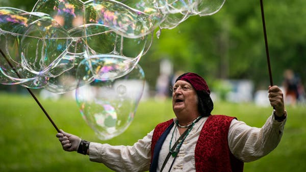 Professional bubble maker creates car-sized floating art