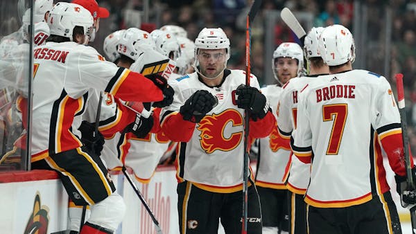 Flames pull away from Wild late