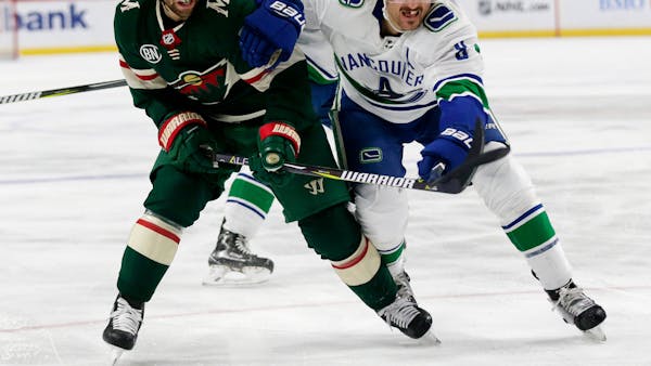 Wild capitalizes on road-weary Canucks