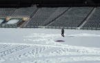 Watch an artist create giant snowflake design at Target Field with just his shoes