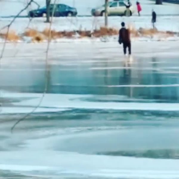People skate on Lake of the Isles