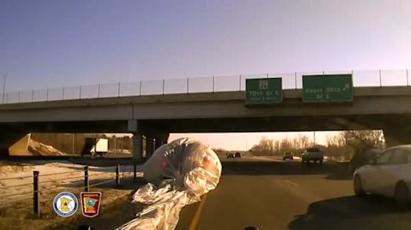 Watch police respond to SUV enveloped in large plastic tarp