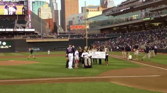 Jack Jablonski threw out the first pitch of Monday's Twins-Yankees game to Justin Morneau.