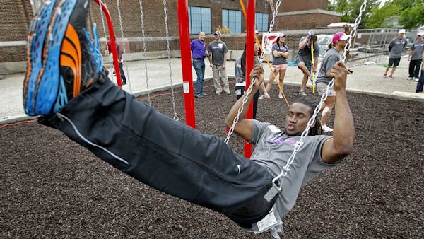 Vikings brawn (and heart) helps build playground