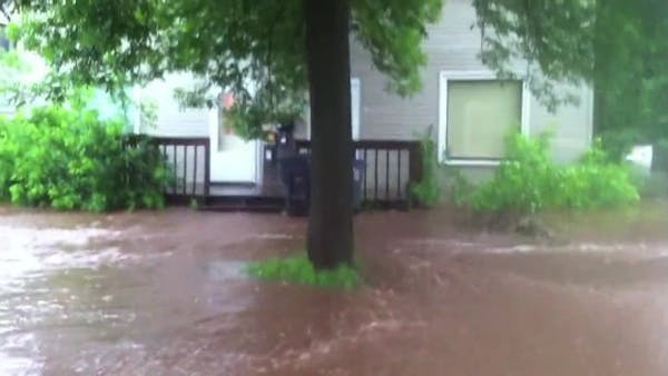 Flood waters surround home in West Duluth