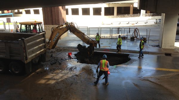 Workers repair a water main break in downtown Minneapolis