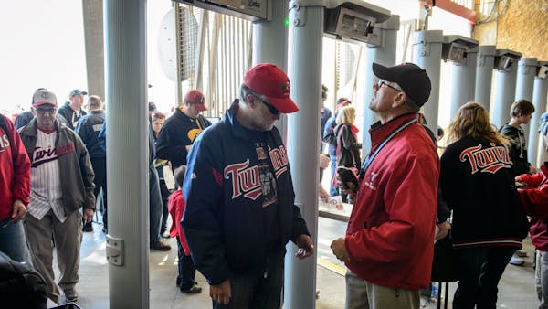 Twins fans pass through metal detectors at Gate 14