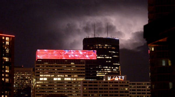 Black helicopters circle storm-lit Mpls. skyline