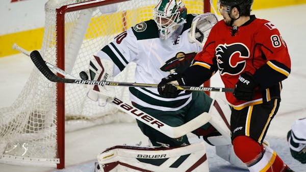 Parise's goal, Dubnyk's saves hold up for Wild's win in Calgary