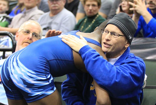 One wrestler's victory, another's hug make for two winners