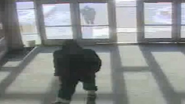 Surveillance video shows two robbery suspects at U