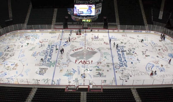Wild season ticket holders paint messages on rink ice