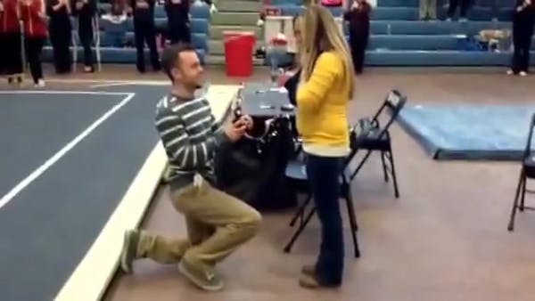 Woman surprised by wedding proposal at gymnastics meet