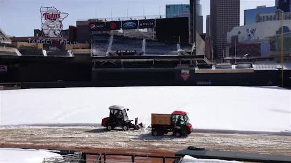 Crews remove snow from Target Field