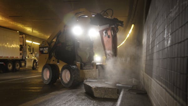 Workers destroy curbs during Lowry Hill Tunnel construction