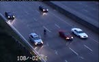Bicyclist takes leisurely ride on I-694 during morning rush hour