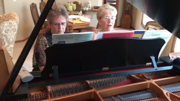 Mary Ann Papke and Maureen Armstrong play piano