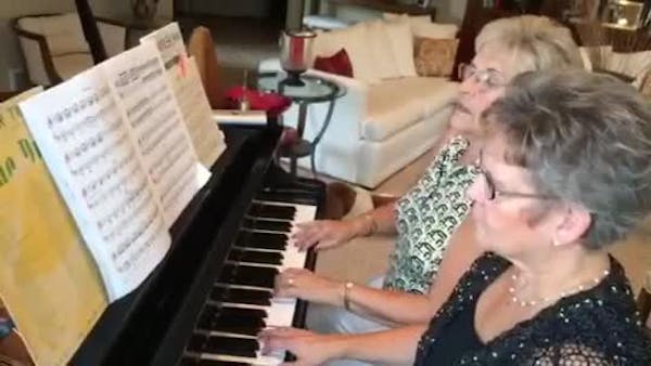 Mary Ann Papke and Maureen Armstrong play piano
