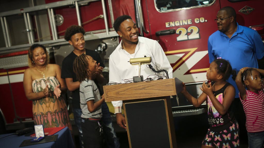 St. Paul Fire Chief gives man an award for valor after he saved ten lives.