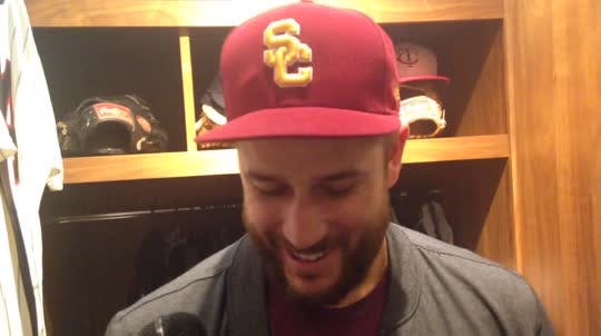 Twins third baseman Trevor Plouffe, wearing a USC cap, talks about his defense and disposes of Jordan Schafer's Notre Dame cap.