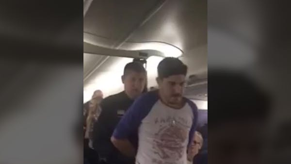 Raw video: Two taken off Delta flight that returned to MSP