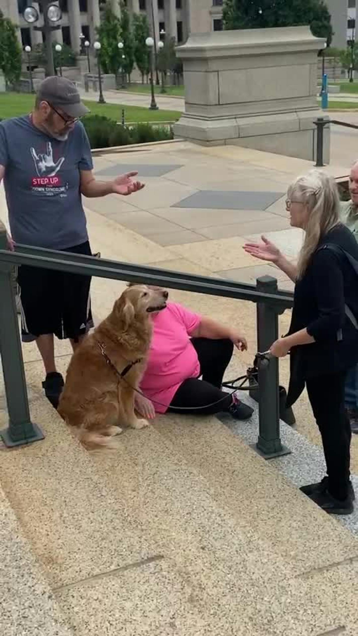 Kiko the golden retriever comforted mourners outside the memorial to the Hortmans