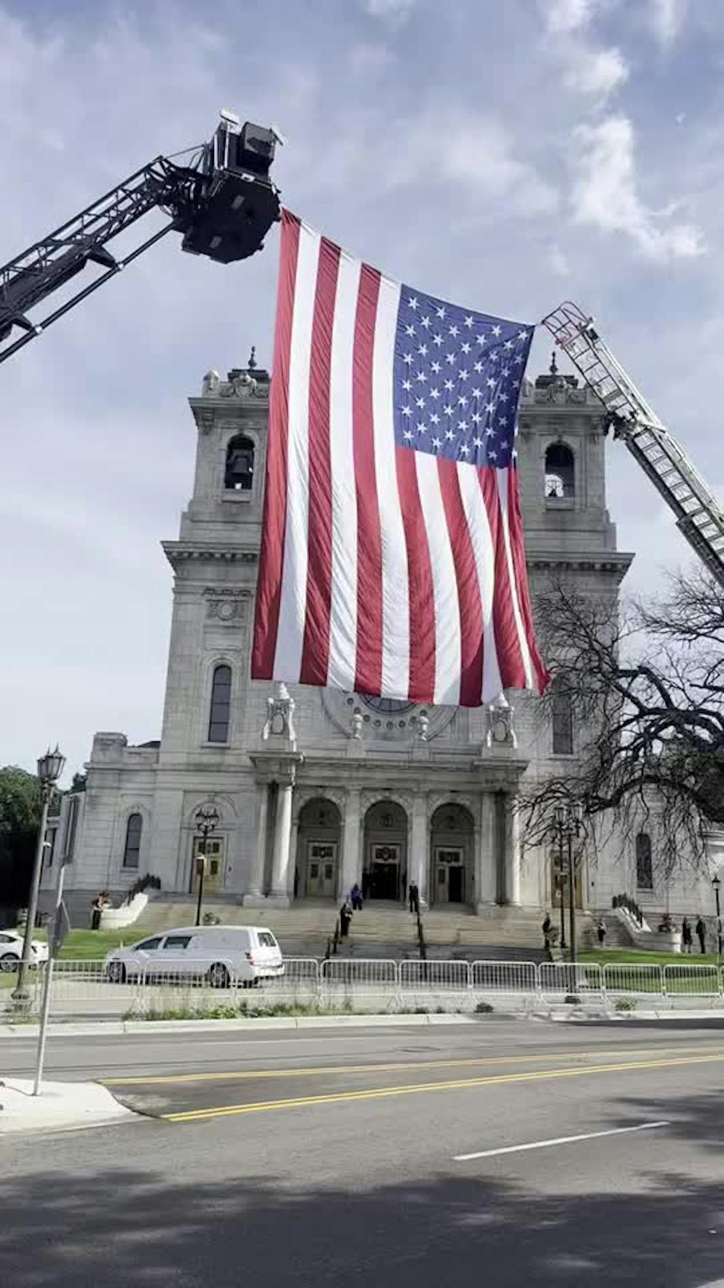 A flag flies outside the Minneapolis Basilica ahead of Hortman funeral Saturday