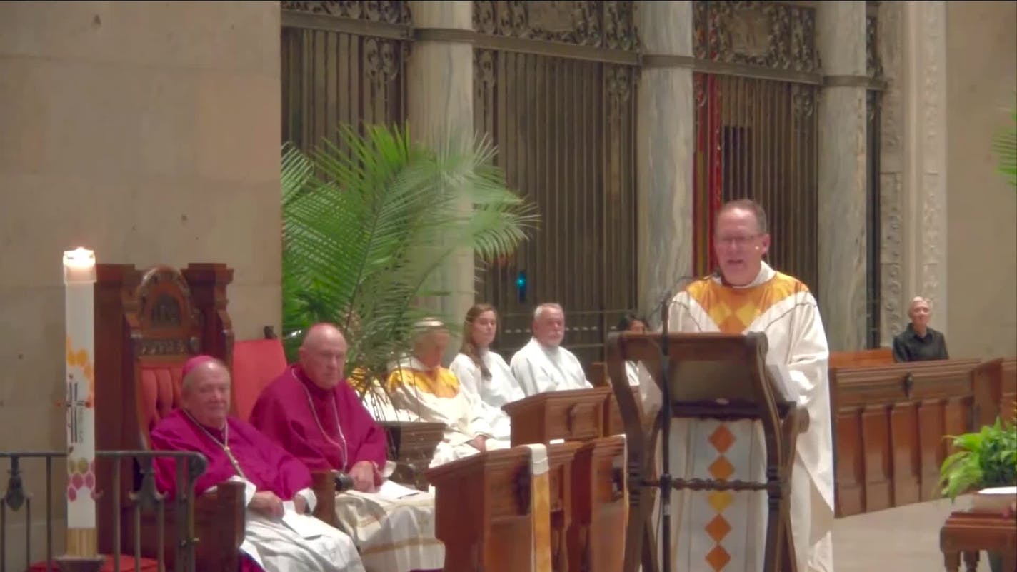 Father Dan Griffith delivers a homily for Melissa and Mark Hortman at the Basilica of St. Mary