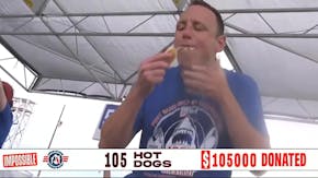 Competitive eater downs 57 hot dogs in 5 minutes